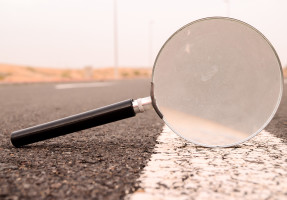Magnifying glass laying on road