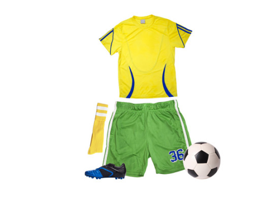Yellow jersey, green athletic shorts, yellow socks, blue cleats, and soccer ball