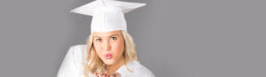 A girl wearing a white graduation cap and gown