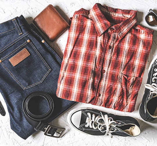 Red and white plaid shirt, blue jeans, black converse, black belt, brown wallet, and sunglasses