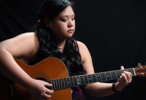 A girl playing guitar