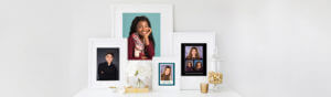 Framed senior portraits sitting on white desk